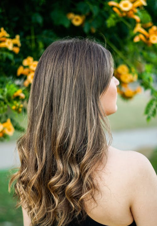 A woman with long, wavy hair in a black dress