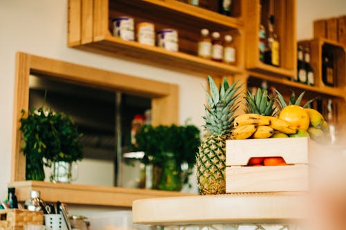 A wooden counter with fruit and vegetables on it