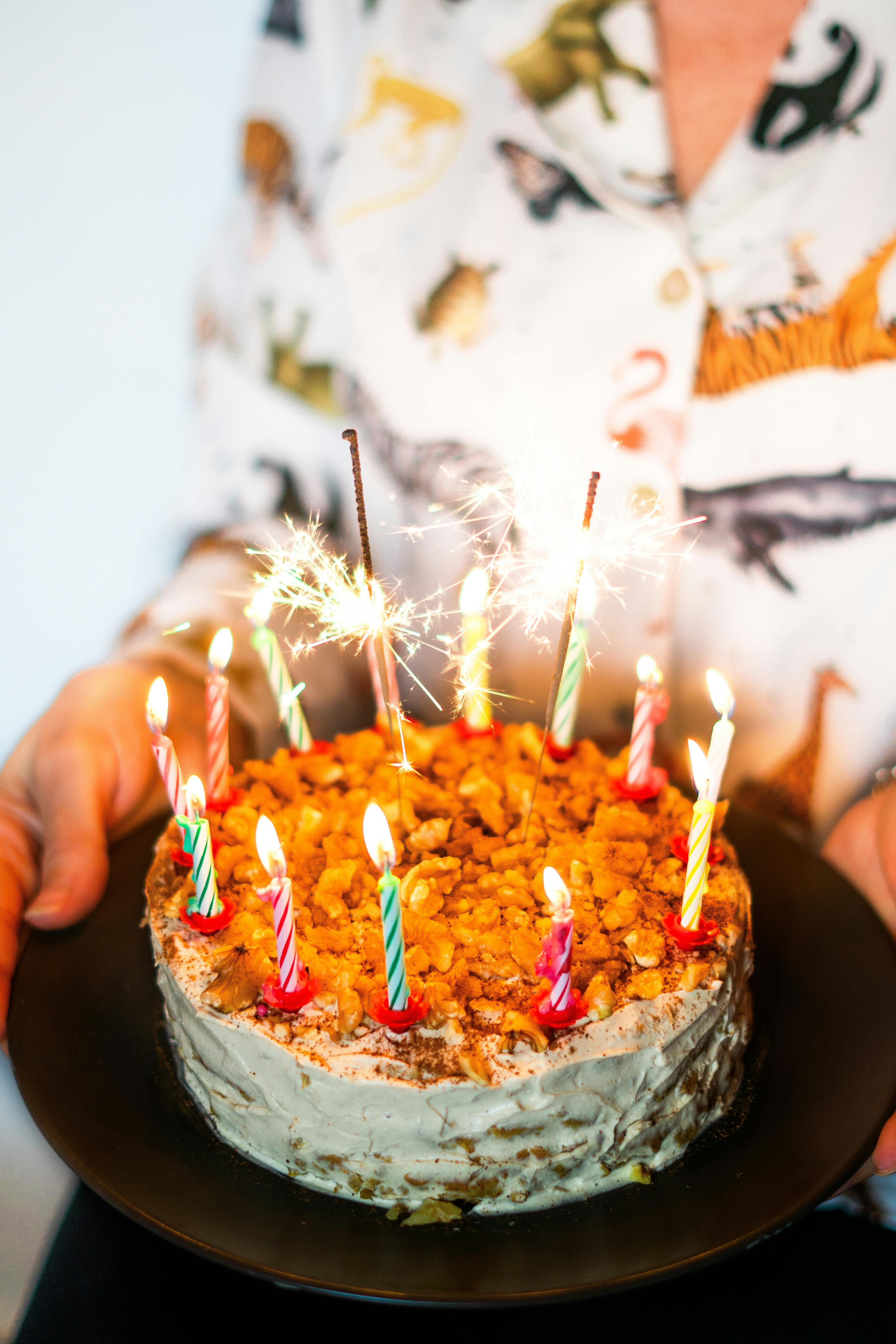 Celebrate with a lit birthday cake adorned with colorful candles and sparklers.