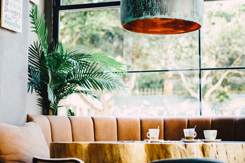 A coffee table with a wooden top and a large pendant light