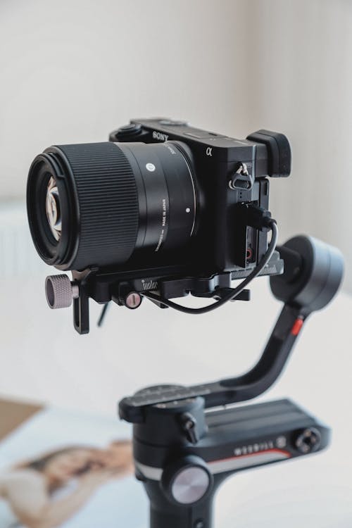 A camera mounted on a tripod with a lens