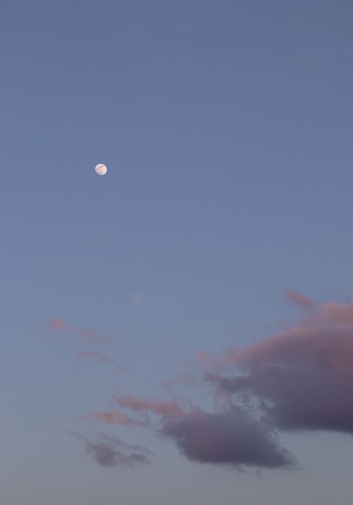 Free A tranquil evening sky featuring the moon and wispy clouds in Santander, Spain. Stock Photo