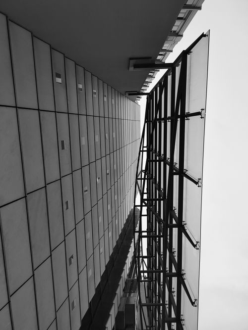 Free Dramatic upward view of modern skyscraper architecture in A Coruña, Spain. Stock Photo