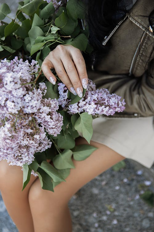 Woman Holding a Bouquet of Lilacs 