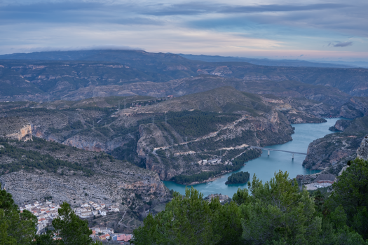 Explore the breathtaking mountainous landscape and river scenery in Cortes de Pallás, Spain.