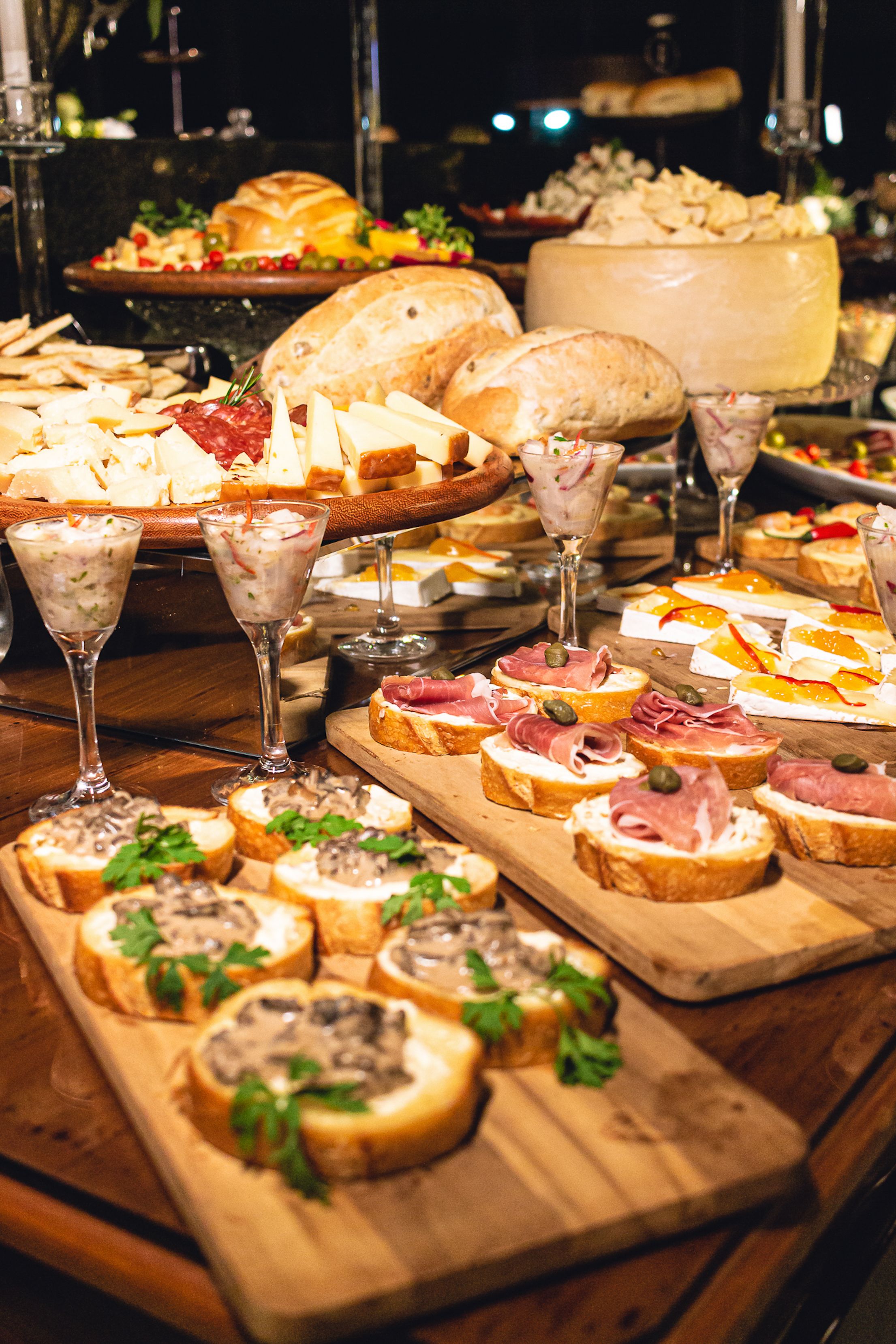 International buffet dinner spread on a Dubai boat cruise featuring grilled meats, salads, and Arabic desserts