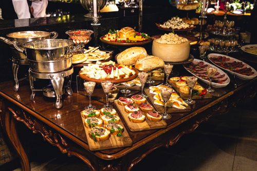 Free A lavish buffet table featuring bread, cheese, meats, and finger foods, ideal for catering events. Stock Photo