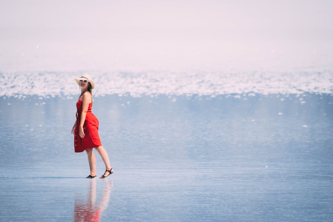 Free Woman Standing on Shore Stock Photo
