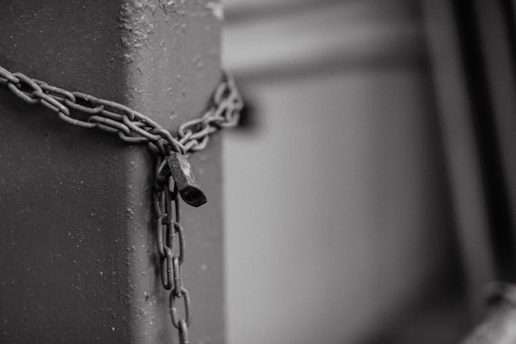 Grayscale Photo Of Steel Chain With Padlock