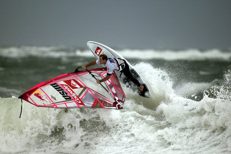 Man Surfing On Waves