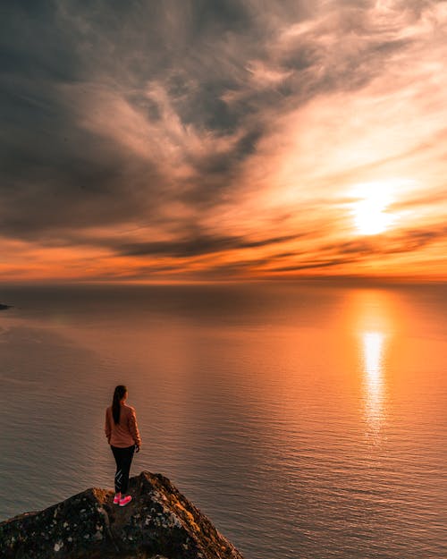 Woman Standing On Cliff