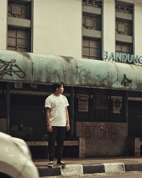 Man Standing In Front of Building