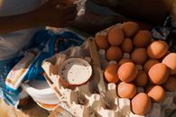 Fresh brown eggs in carton with knife on a table in Luanda market.