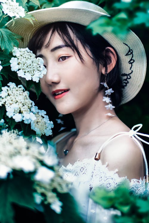 Photo of Woman Near White Flowers