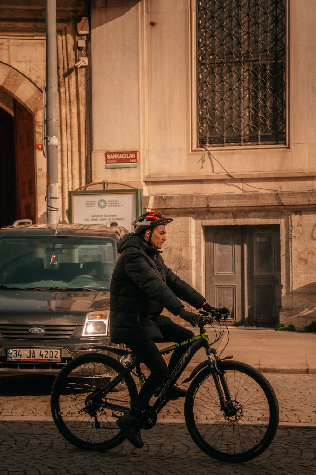 Cyclist riding through an urban street while wearing protective gear