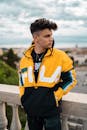 Man Wearing Yellow and Black Fila Jacket