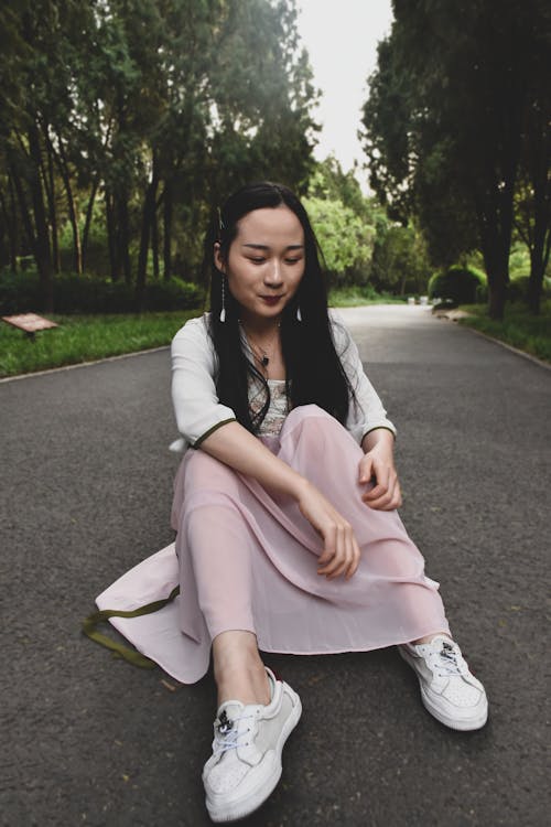Photo of Woman Sitting On Road