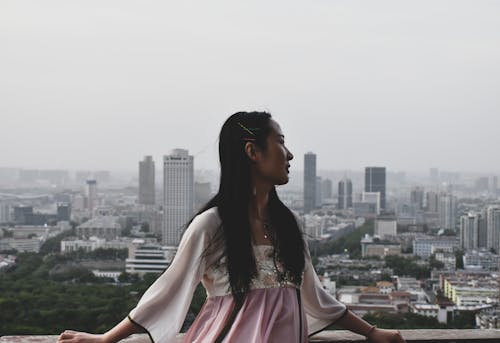 Woman Wearing White and Pink Dress Lean on Railings