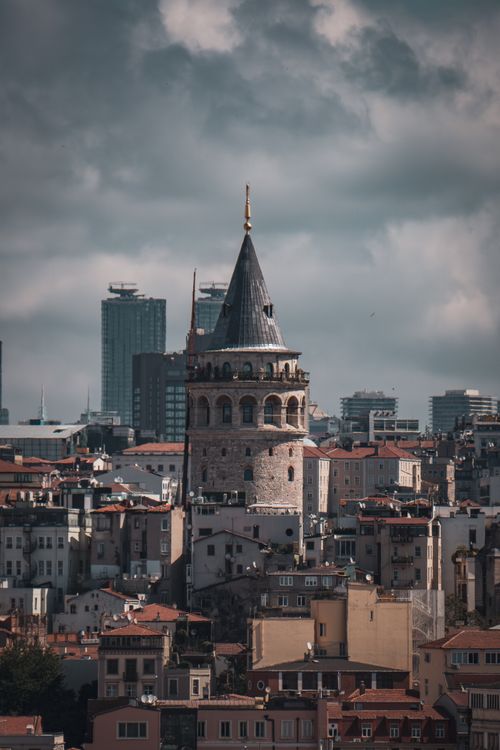 Free Moody view of Galata Tower amidst Istanbul's skyline captures the essence of the city. Stock Photo