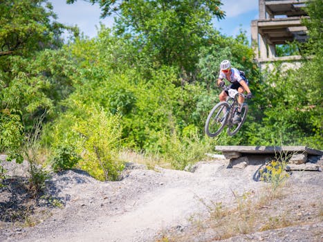 Mountain biker jumps over rocky terrain performing a stunt in Tulcea, Romania.