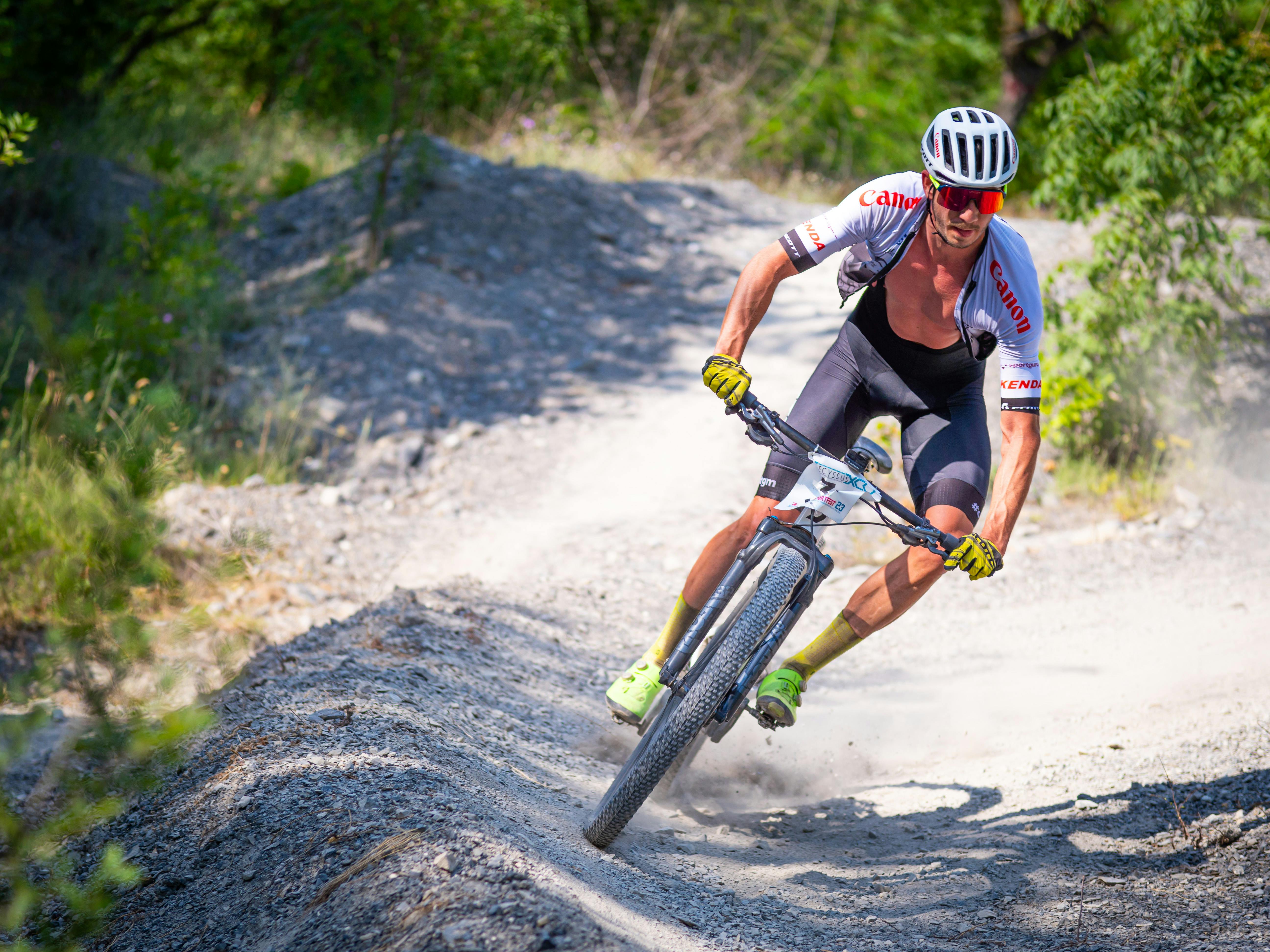 Mountain biker riding through forest trail