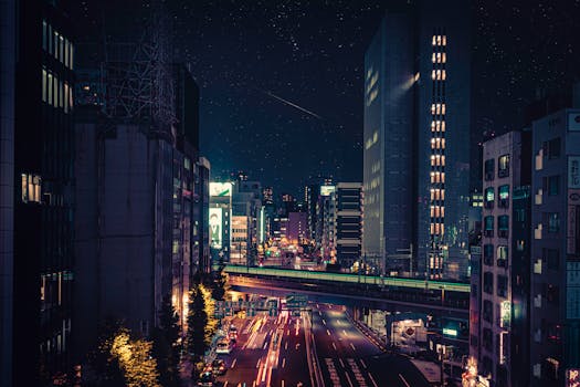 Stunning Tokyo night view showcasing illuminated skyscrapers and vibrant traffic trails under a starlit sky.