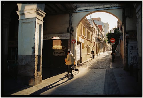 A person walking down a narrow alleyway
