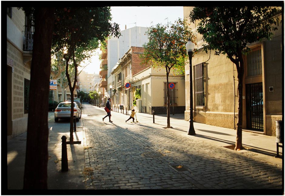 Best Fitness Trackers and Smartwatches: Complete Buying Guide 2026 A child and an adult stroll down a cobblestone street in Barcelona, surrounded by trees and urban architecture.