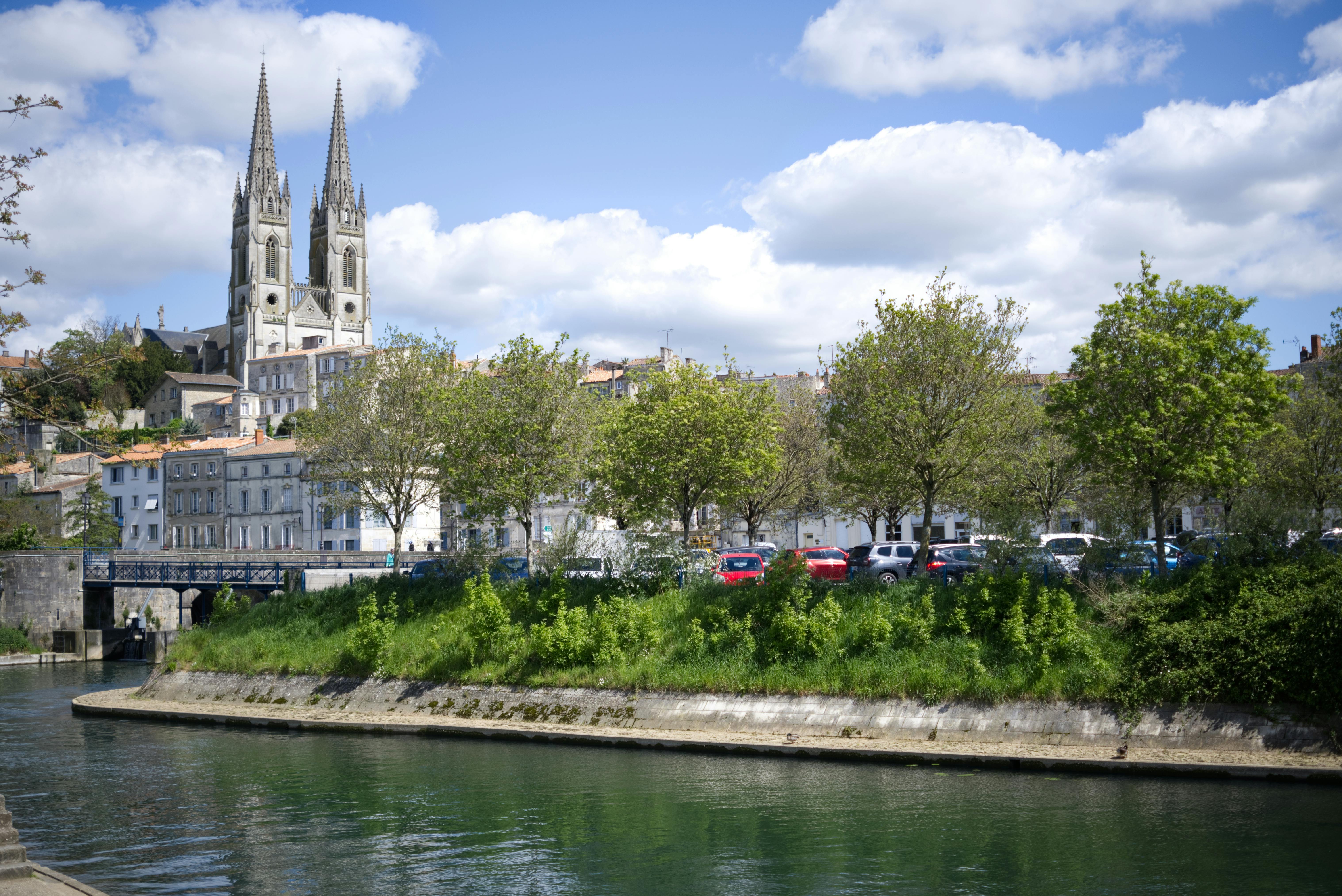 View of the Eglise Notre-Dame De Niort with the river in the foreground, in Niort, France.
