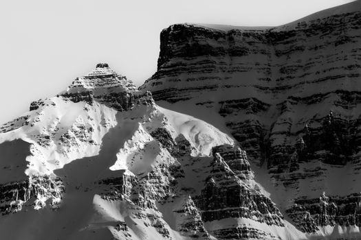 Captivating black and white image of snow-covered mountains in Banff, Canada.