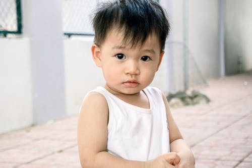 Close-up Portrait Photo of Boy in White Vest