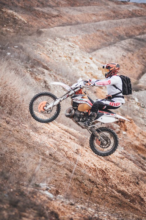 Person Driving Motocross Dirt Bike Outdoors