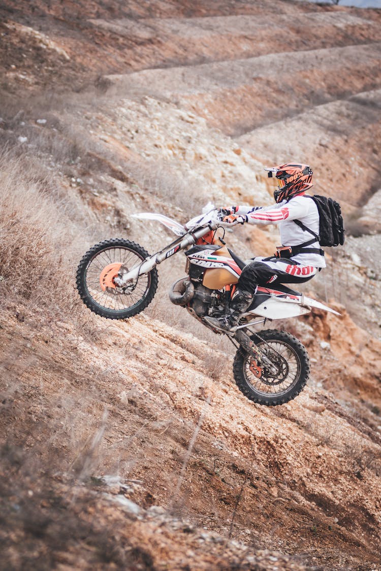 Person Driving Motocross Dirt Bike Outdoors