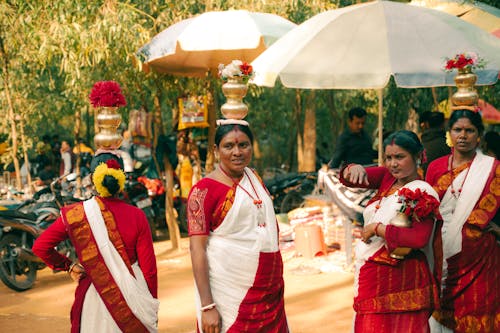 A group of women in red and white saris