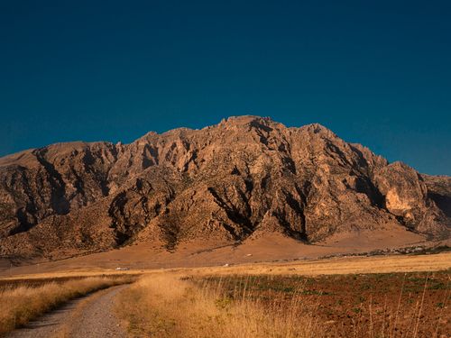 Free Explore the rugged beauty of Duhok's mountain landscape at sunset, a serene natural setting in Iraq. Stock Photo