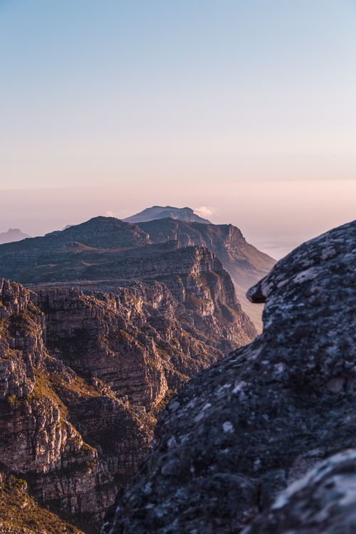 Free A breathtaking view of Table Mountain's rugged cliffs at sunrise, Cape Town. Stock Photo