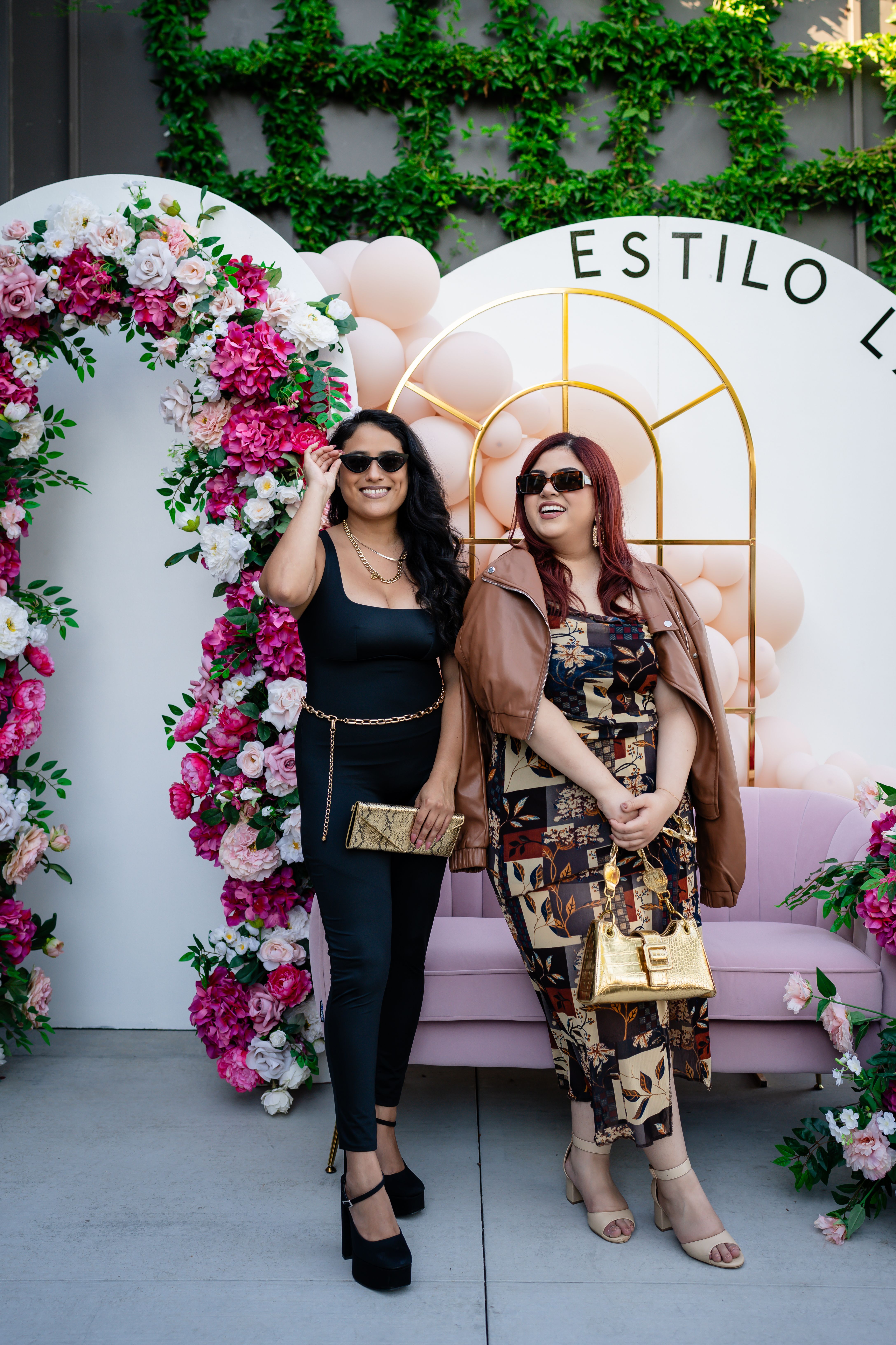 Fashionable Women Standing in Front of a Wall with Flowers · Free Stock ...