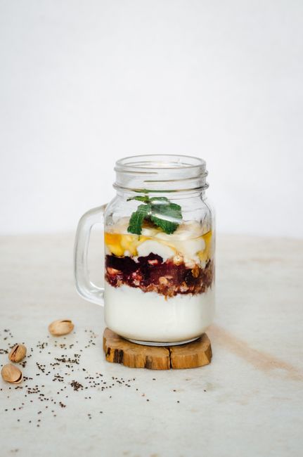 Vibrant layered breakfast jar with yogurt, fruit, and toppings, perfect for a healthy start.