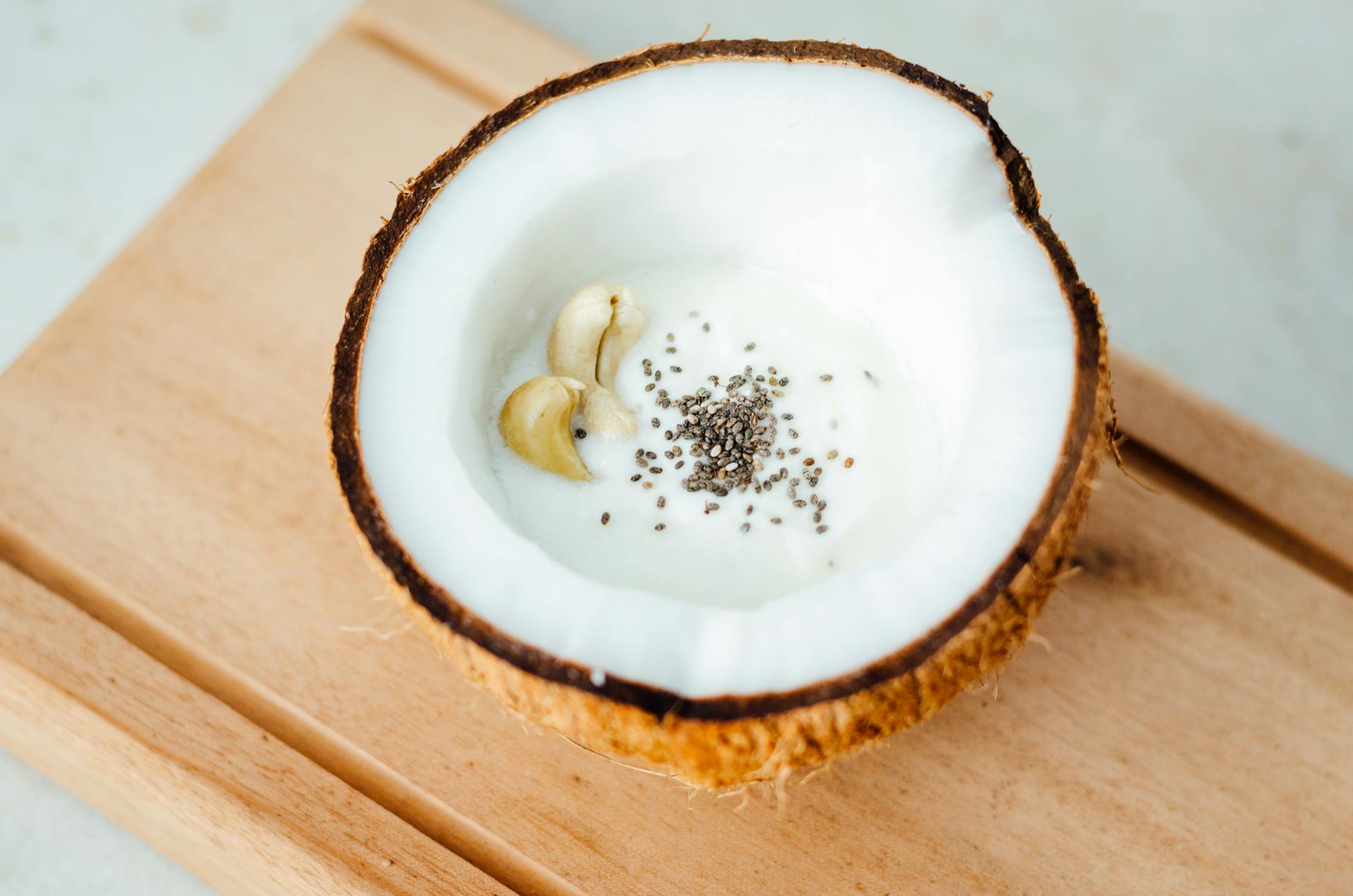 Coconut Milk with Cashew Nuts and Chia Seeds in Half a Coconut