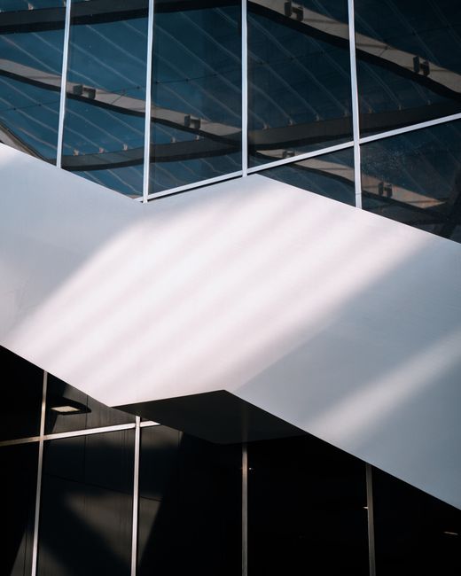 A modern architectural structure in Brussels showcasing reflections and geometric lines.