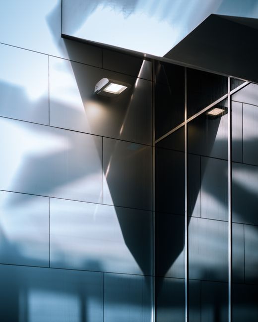 Sleek modern building facade with reflections in Saint-Josse-ten-Noode, Brussels.