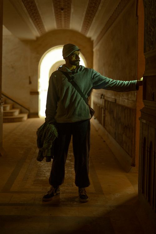 Free Artistic silhouette of a man in a historic Baghdad hallway, creating a dramatic mood. Stock Photo