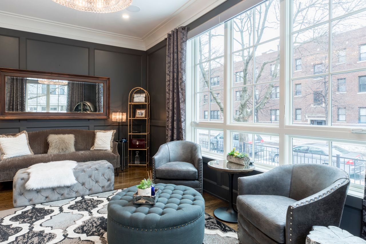 Round tufted gray ottoman in an elegant living room