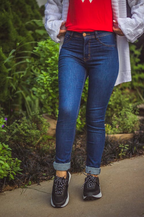 Woman Standing on Brown Pathway