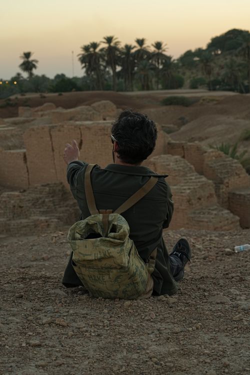 Free Man exploring ancient ruins in Baghdad, Iraq at sunset, highlighting historical significance. Stock Photo