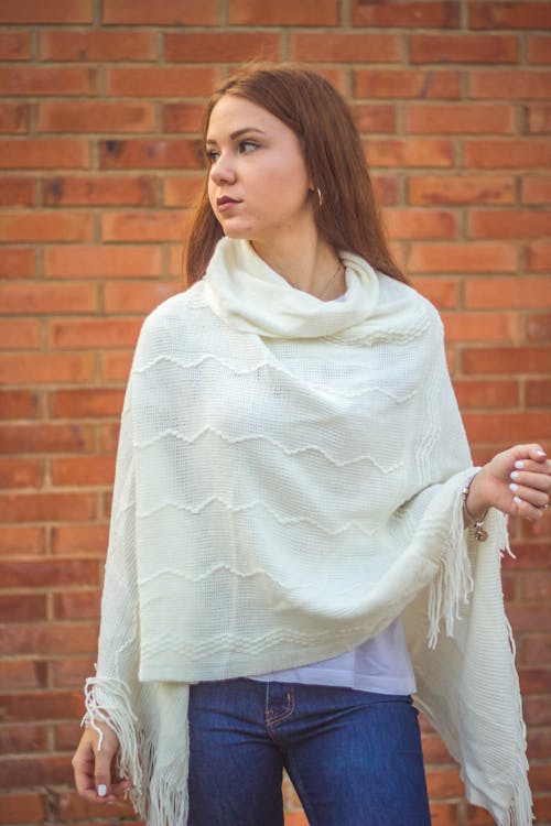 Woman wearing a white shawl looking sideways