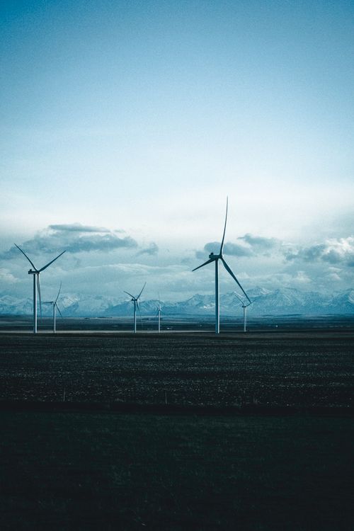 Free Wind turbines on a vast landscape with mountains in Waterton Park, Canada. Stock Photo