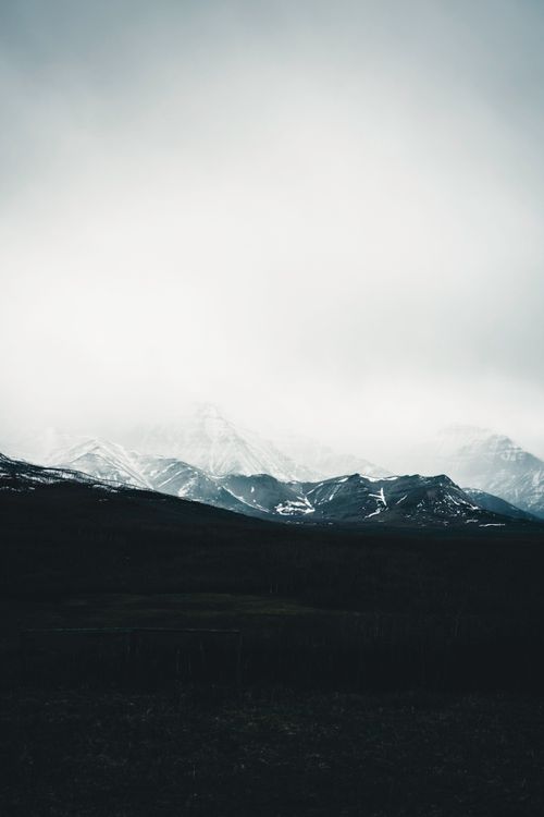 Free Gloomy winter view of misty mountains in Waterton Park, Alberta, Canada. Stock Photo