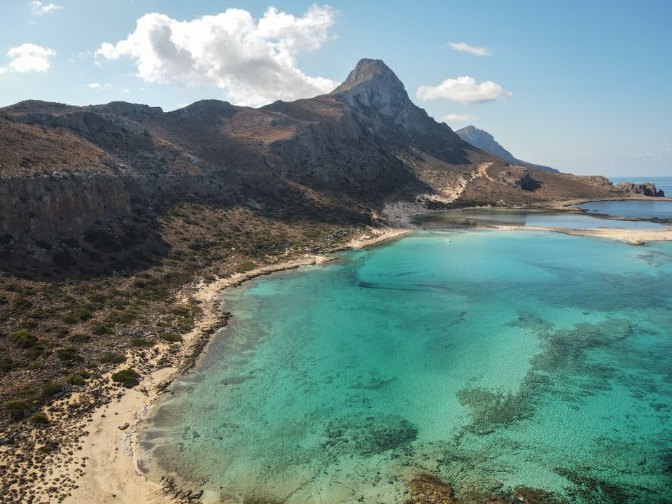 White mountains above a turquoise Cretan bay