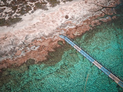 An aerial view of a pier in the ocean